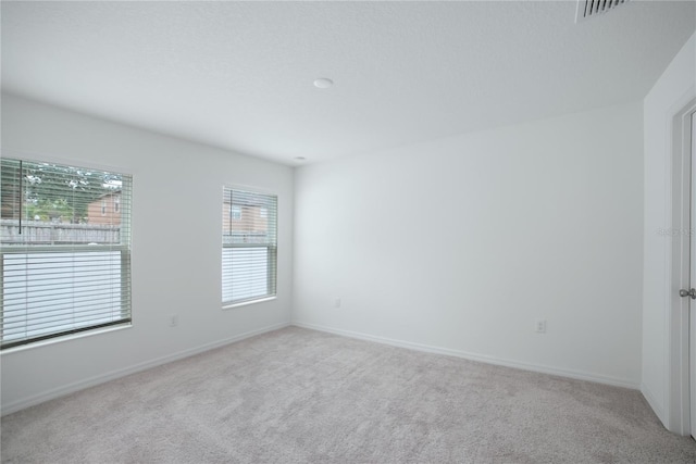 empty room with light colored carpet