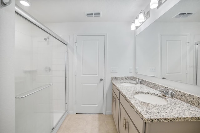 bathroom featuring tile patterned flooring, vanity, and an enclosed shower