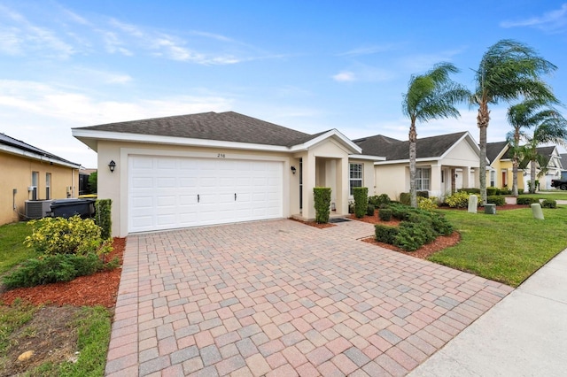 ranch-style house featuring cooling unit, a front yard, and a garage