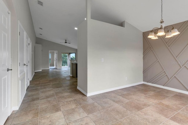 unfurnished room with light tile patterned floors, ceiling fan with notable chandelier, and lofted ceiling