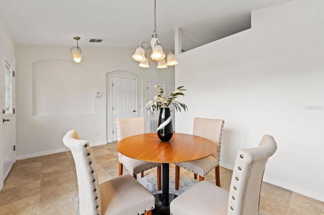 dining area with an inviting chandelier