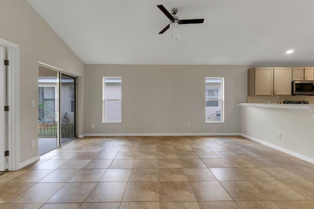 unfurnished living room featuring ceiling fan, light tile patterned flooring, and lofted ceiling