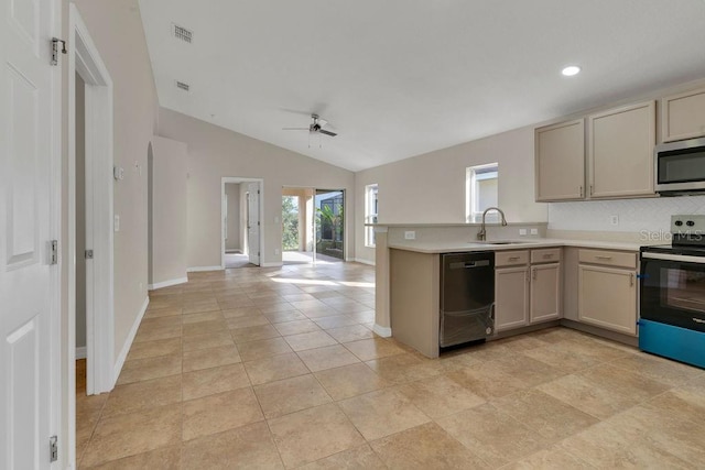 kitchen with kitchen peninsula, appliances with stainless steel finishes, vaulted ceiling, ceiling fan, and sink