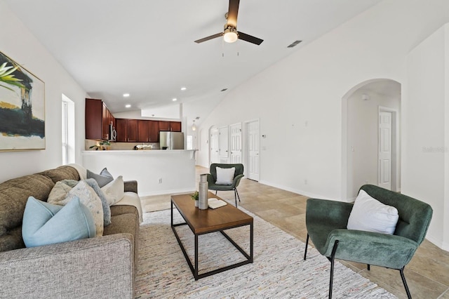 living room with ceiling fan and high vaulted ceiling