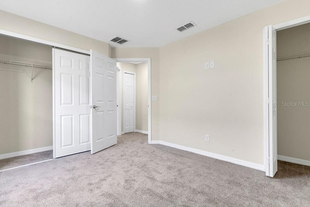 unfurnished bedroom featuring light colored carpet