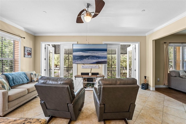 living room featuring ornamental molding, light tile patterned floors, and ceiling fan