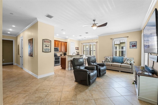 living room with visible vents, ornamental molding, a ceiling fan, light tile patterned flooring, and baseboards