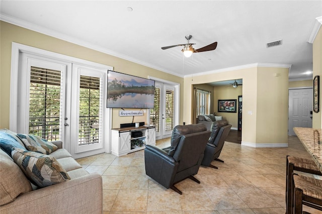 living room with ceiling fan, light tile patterned floors, and crown molding