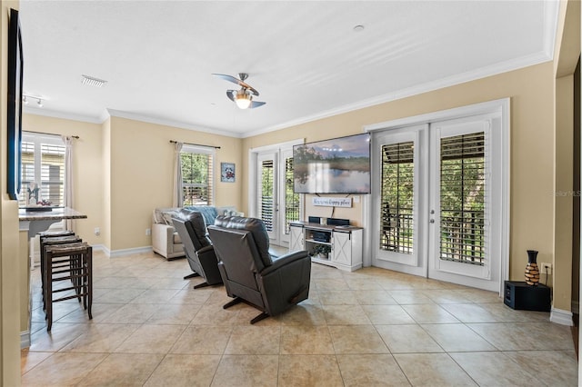 living area with plenty of natural light, baseboards, light tile patterned floors, and ornamental molding