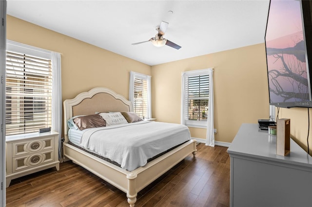 bedroom featuring a ceiling fan, baseboards, and dark wood-style flooring