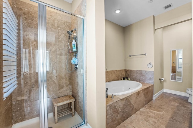 bathroom with visible vents, baseboards, toilet, a garden tub, and a stall shower