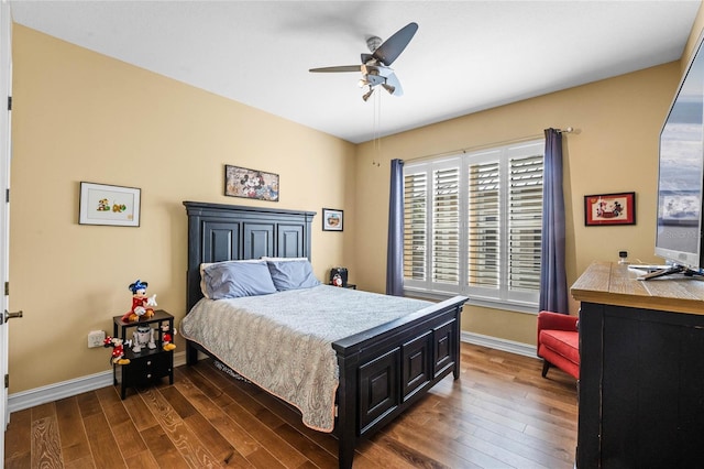 bedroom with ceiling fan, baseboards, and dark wood-style floors