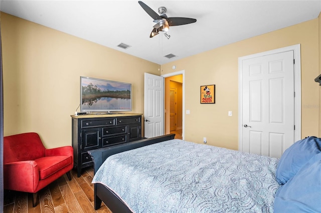 bedroom featuring a ceiling fan, wood finished floors, and visible vents