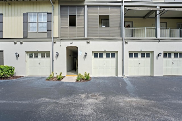 multi unit property featuring a balcony and a garage