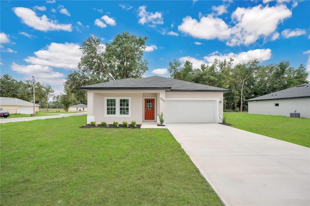 view of front of house featuring a garage, a front yard, and central air condition unit