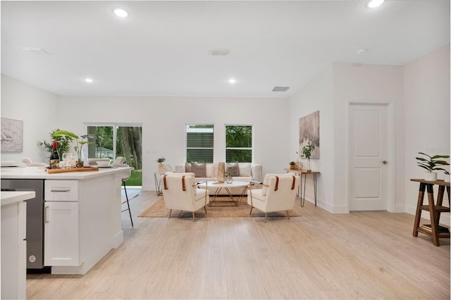 living room featuring plenty of natural light and light hardwood / wood-style flooring