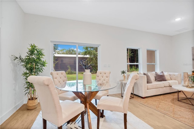 dining space with light wood-type flooring