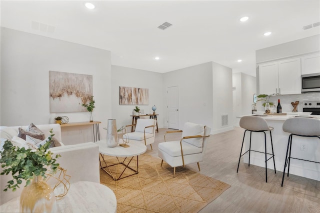 living room with light hardwood / wood-style flooring