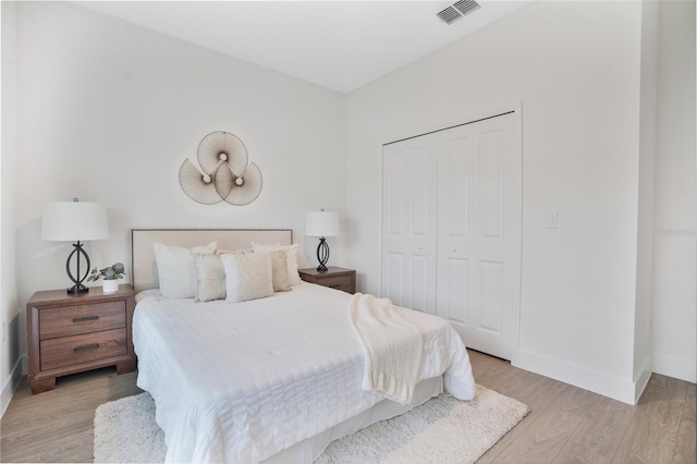 bedroom featuring a closet and light wood-type flooring