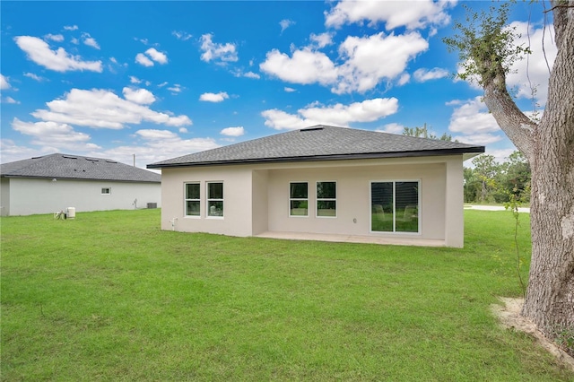 back of house with a lawn