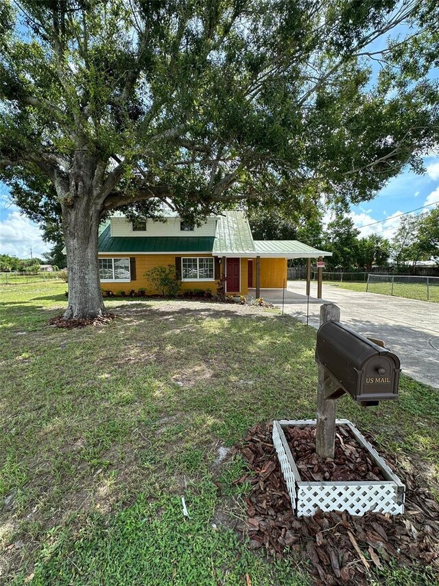 view of front of house with a front yard and a carport