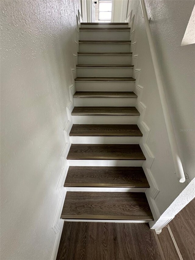 stairs with hardwood / wood-style flooring