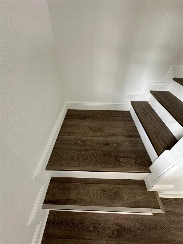 stairway with hardwood / wood-style flooring