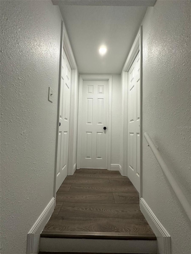 corridor with dark wood-type flooring