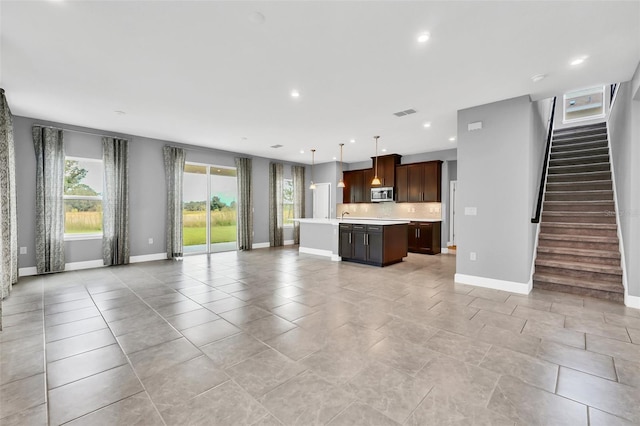 unfurnished living room with light tile patterned floors