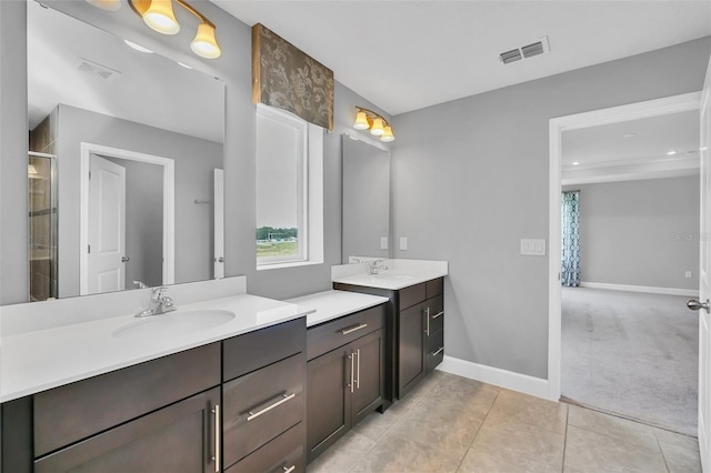 bathroom with vanity, an enclosed shower, and tile patterned floors