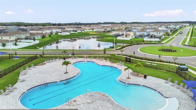 view of swimming pool with a water view and a patio