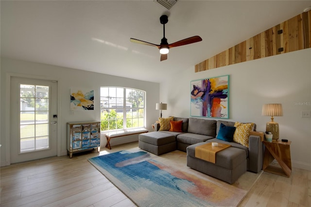 living room with high vaulted ceiling, ceiling fan, and light hardwood / wood-style floors