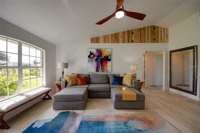 living room featuring light wood-type flooring, high vaulted ceiling, and ceiling fan