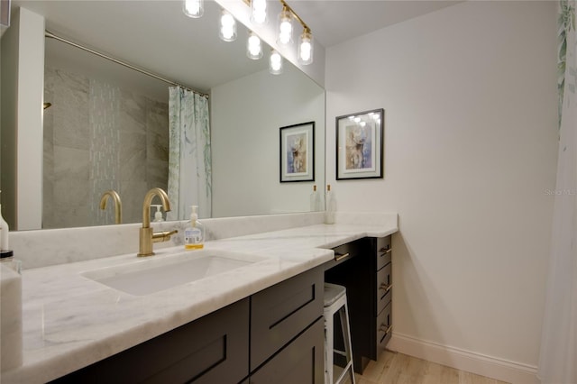 bathroom with hardwood / wood-style floors, a shower with curtain, and vanity