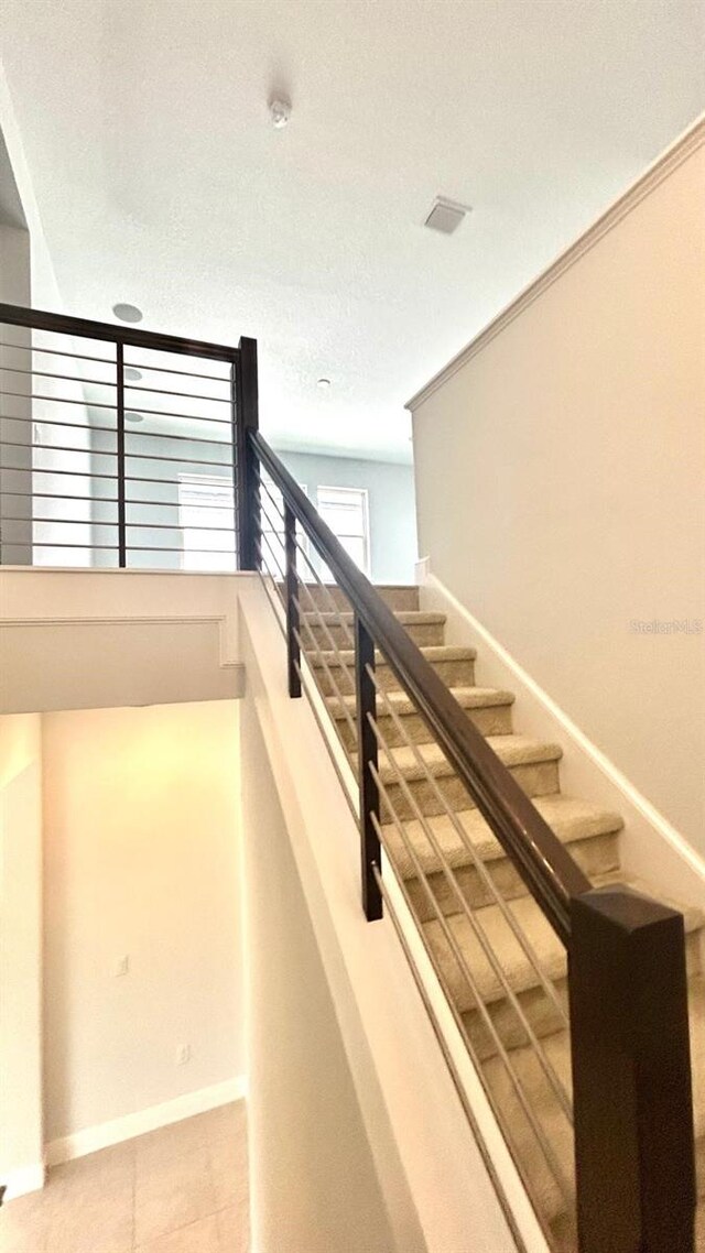 stairway with a textured ceiling