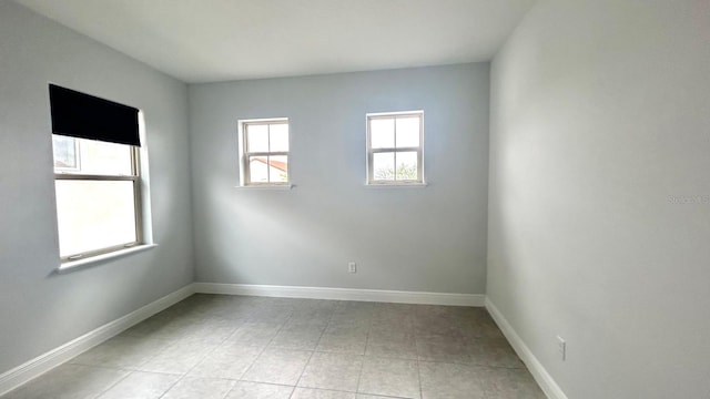 unfurnished room with light tile patterned floors