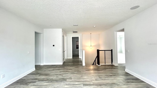 empty room featuring hardwood / wood-style floors and a textured ceiling