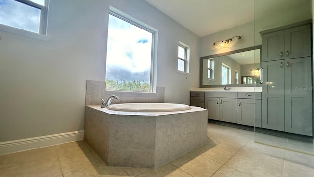 bathroom featuring vanity, tiled tub, and tile patterned floors