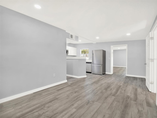 unfurnished living room with light hardwood / wood-style flooring