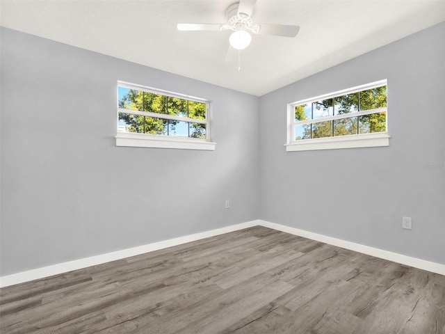 empty room featuring lofted ceiling, ceiling fan, and light hardwood / wood-style flooring