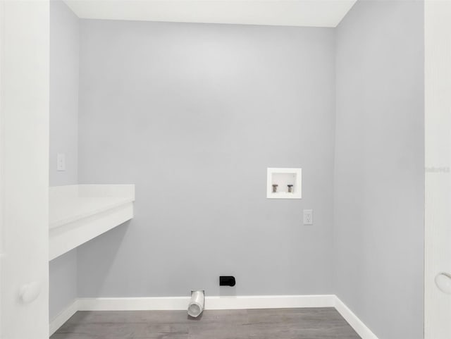 clothes washing area with hookup for a washing machine, hardwood / wood-style floors, and electric dryer hookup