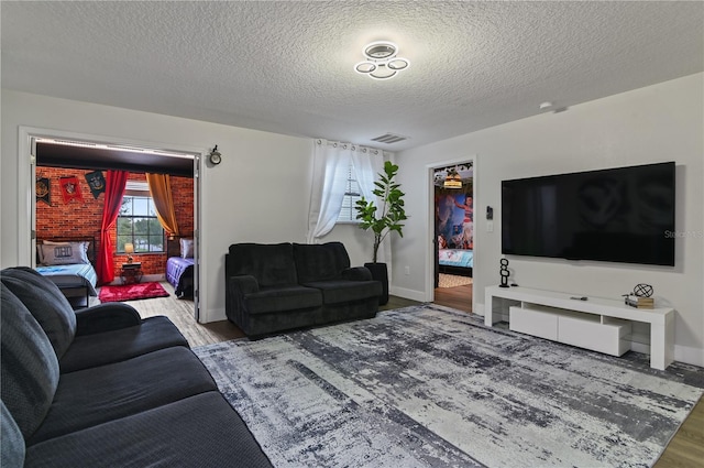 living room with a textured ceiling and hardwood / wood-style flooring