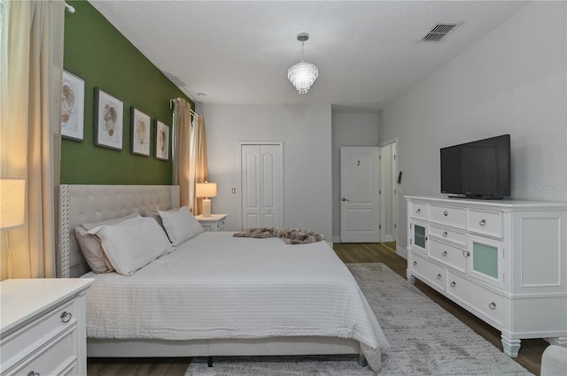 bedroom with a closet and dark hardwood / wood-style floors