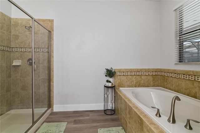 bathroom with independent shower and bath and hardwood / wood-style flooring