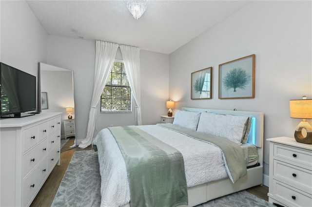 bedroom with dark hardwood / wood-style floors