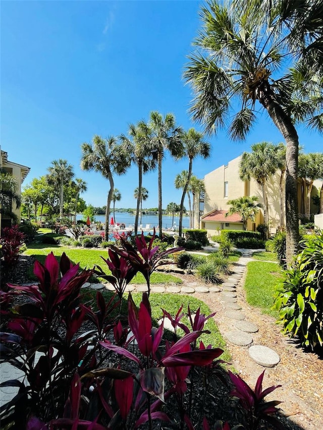 surrounding community featuring a lawn and a water view