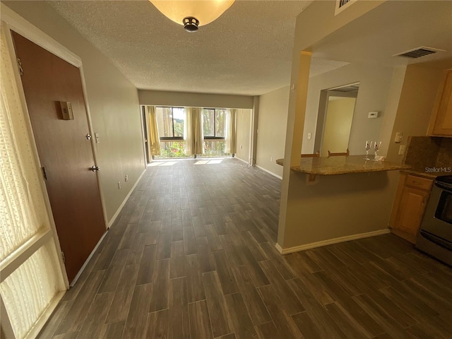 hallway featuring a textured ceiling and dark hardwood / wood-style floors