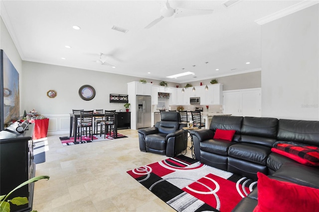 living room featuring ornamental molding and ceiling fan