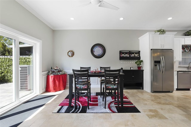 dining space with ornamental molding and ceiling fan