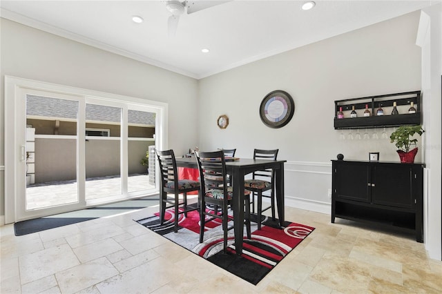 dining space with ornamental molding and ceiling fan